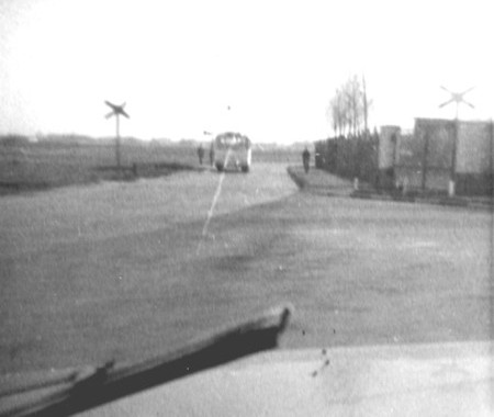 Railway crossing on Butzweilerweg.  This line led into the RAF Station and was used for transporting goods in and out of the site.  A 28 bus can just be seen in the background.